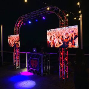 Outdoor DJ booth with colorful lighting