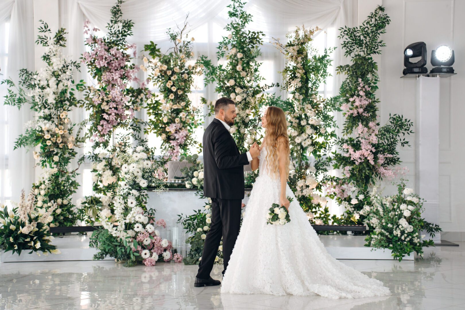 Elegant wedding couple surrounded by floral decorations