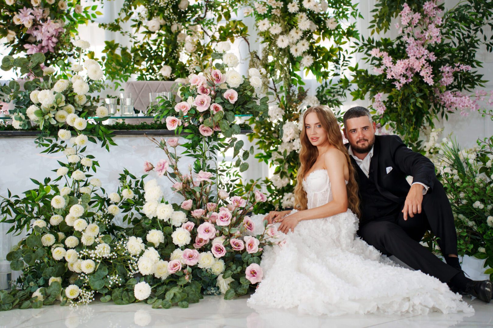 Wedding couple surrounded by flowers