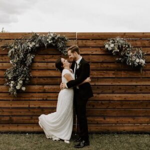 Romantic wedding kiss in outdoor setting