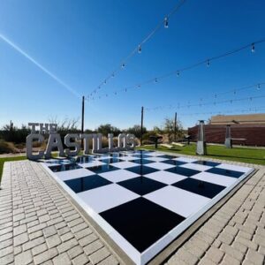 Large chessboard on patio under lights