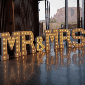 Rustic venue with glowing "MR & MRS" sign