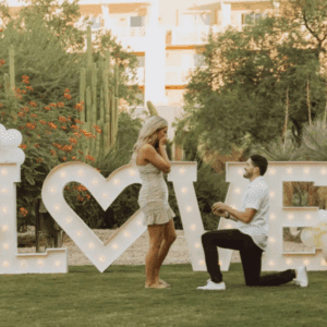 Man proposing to woman with balloons